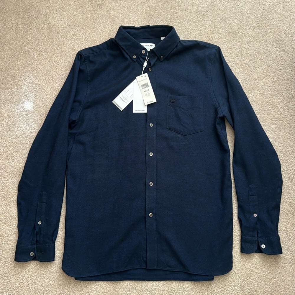 Lacoste soft cotton button up dress shirt. It is NWT.  Size medium navy blue.